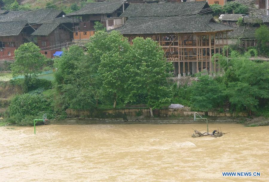 Photo taken on May 7, 2013 shows a basketball field is submerged by floods at Jidao Miao Village of Kaili City, southwest China's Guizhou Province. The central, south central and southeast parts of Guizhou were hit by hails and storms from Monday to Tuesday, disturbing local traffic and power service and causing damage to agricultural production. (Xinhua/Chen Peiliang)