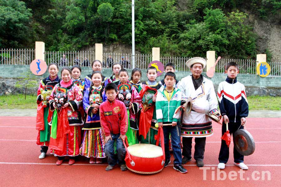 Ban Wenyu, a heritor of "Zhou Dance" instructs the local students for cultivating many little inheritors. [Photo/China Tibet Online]