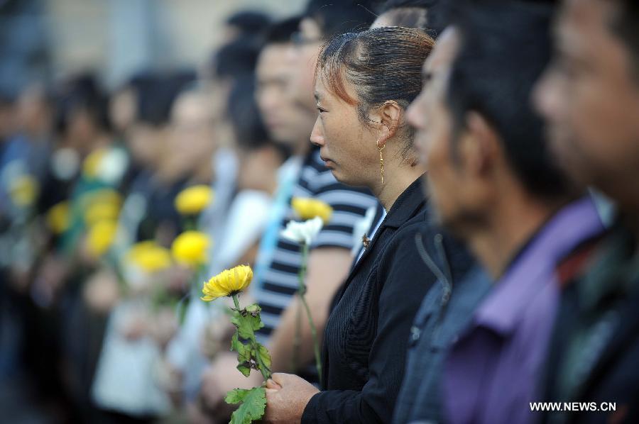 Residents mourn for victims who died in a massive earthquake five years ago in the old county seat of Beichuan, southwest China's Sichuan Province, May 12, 2013. A memorial event was held in Beichuan on Sunday to mark the fifth anniversary of the deadly earthquake which havoced Sichuan on May 12, 2008. (Xinhua/Xue Yubin) 