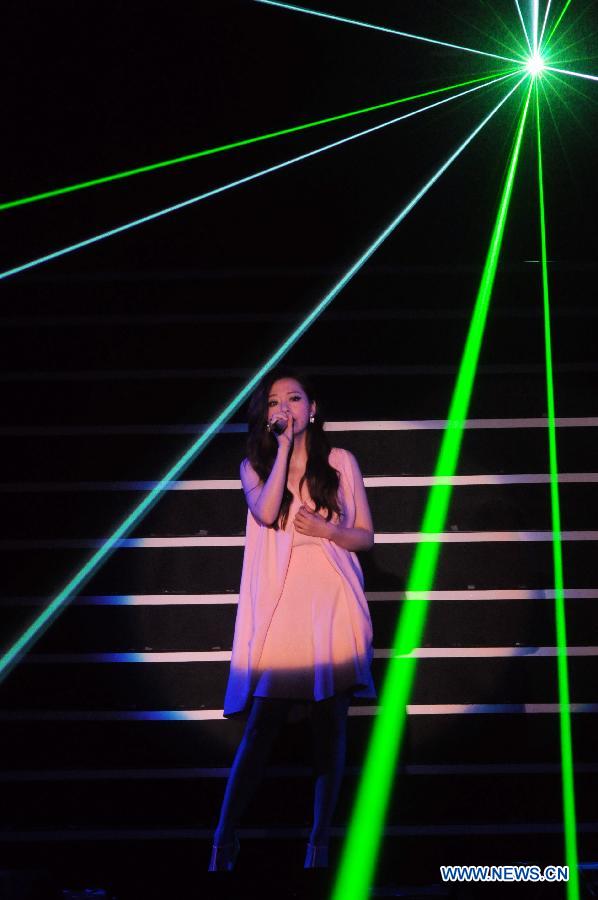 Singer Zhang Liangying performs during a memorial concert for Teresa Teng held in the Taipei Arena in Taipei, southeast China's Taiwan, May 12, 2013. The concert marks the 18th anniversary of the death and 60th anniversary of the birth of Teresa Teng (1953-1995), one of the most famous pop singers in China. (Xinhua/Wu Ching-teng)
