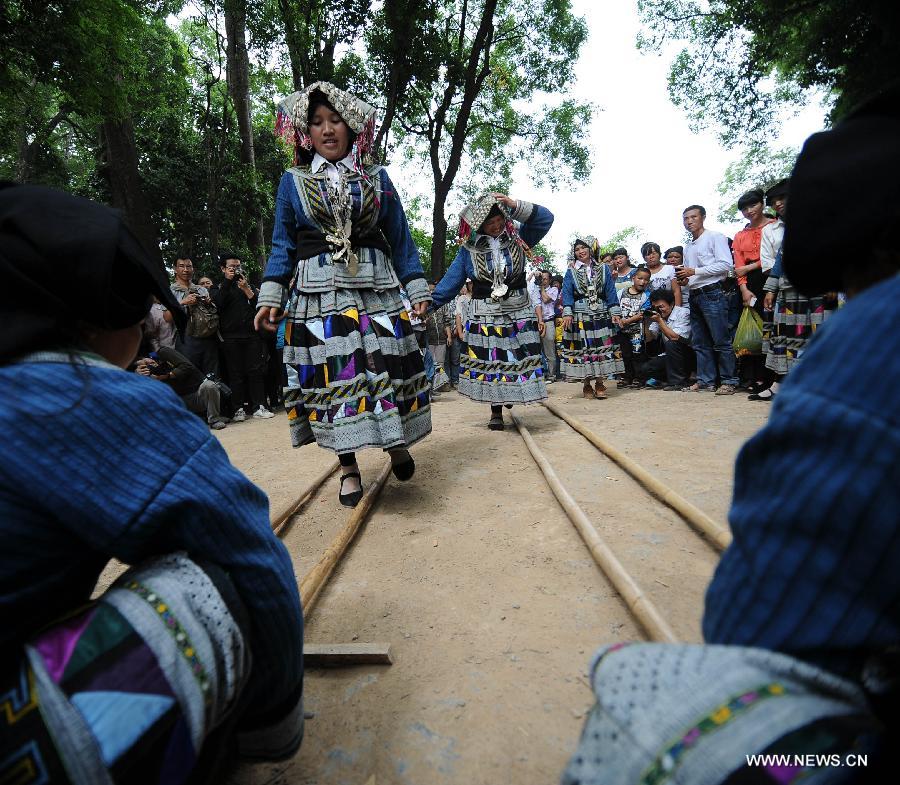 Bailuo people celebrate their traditional "Qiaocai Festival" at Chengzhai Village in Malipo County of Wenshan Zhuang-Miao Autonomous Prefecture, southwest China's Yunnan Province, May 14, 2013. The Bailuo people living in Wenshan is a subline of the Yi ethnic group. The Qiaocai Festival, one of the Bailuo people's most important festival, was celebrated at Chengzhai Village on Tuesday. During the festival, the Bailuo people dress in their folk costumes and perform their traditional dancing. (Xinhua/Qin Lang) 