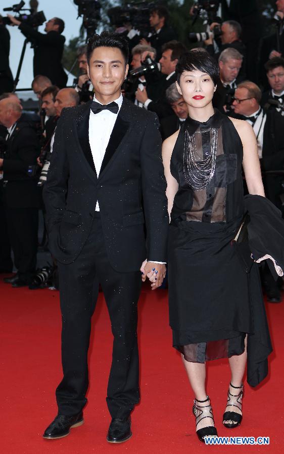 Chinese actor Chen Kun (L) and director Flora Lau arrive on the red carpet for the opening ceremony of the 66th annual Cannes Film Festival in Cannes, France, May 15, 2013. The festival runs from May 15 to 26. (Xinhua/Gao Jing)