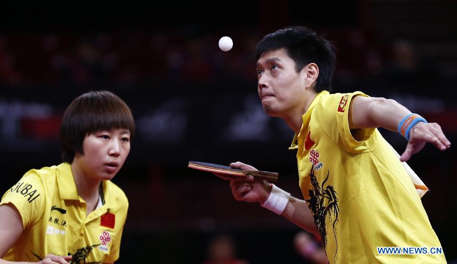 Qiu Yike (R) and Wen Jia of China compete during the round of 16 of mixed doubles against Jiang Tianyi and Lee Ho Ching from Hong Kong of China at the 2013 World Table Tennis Championships in Paris, France on May 16, 2013. Qiu Yike and Wen Jia lost 2-4. (Xinhua/Wang Lili)