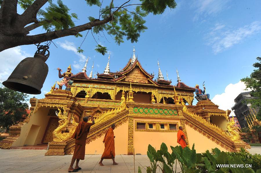 Monks visit the Zongfo Temple in Jinghong of Xishuangbanna Prefecture in southwest China's Yunnan Province, May 16, 2013. The Zongfo Temple, which covers an area of more than 3,000 square meters and has a history of over 1,000 years, has seen completion of its overhaul and is now open free to the public. (Xinhua/Chen Haining) 