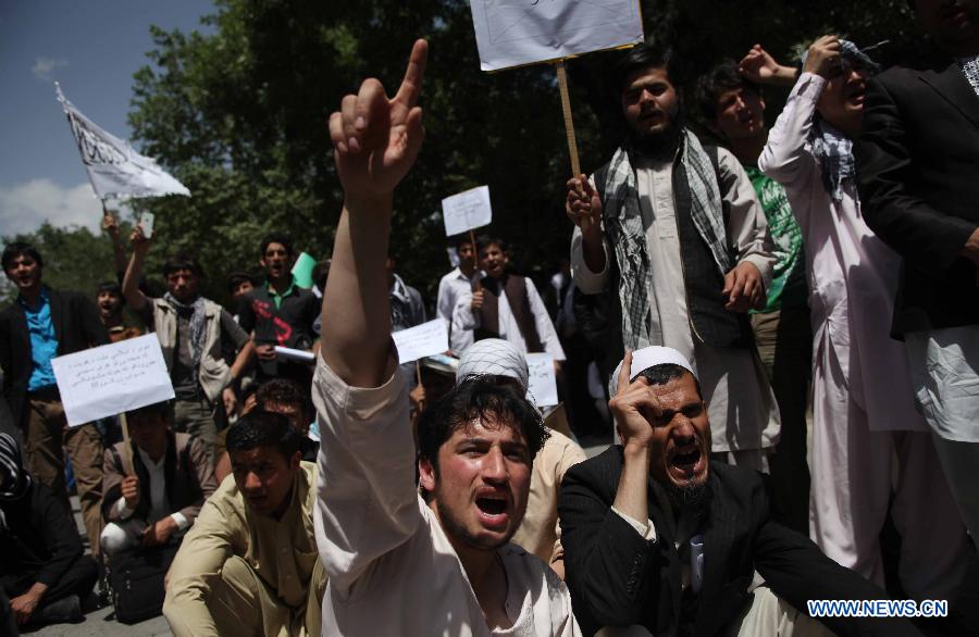 Afghan university students chant slogans during a protest against the Elimination of Violence against Women (EVAW) law, in Kabul Afghanistan on May 22, 2013. The protesters said parts of the EVAW law, endorsed by Afghan President Hamid Karzai in 2009, are against Islamic teaching. The law has yet to be ratified by the parliament. (Xinhua/Ahmad Massoud)