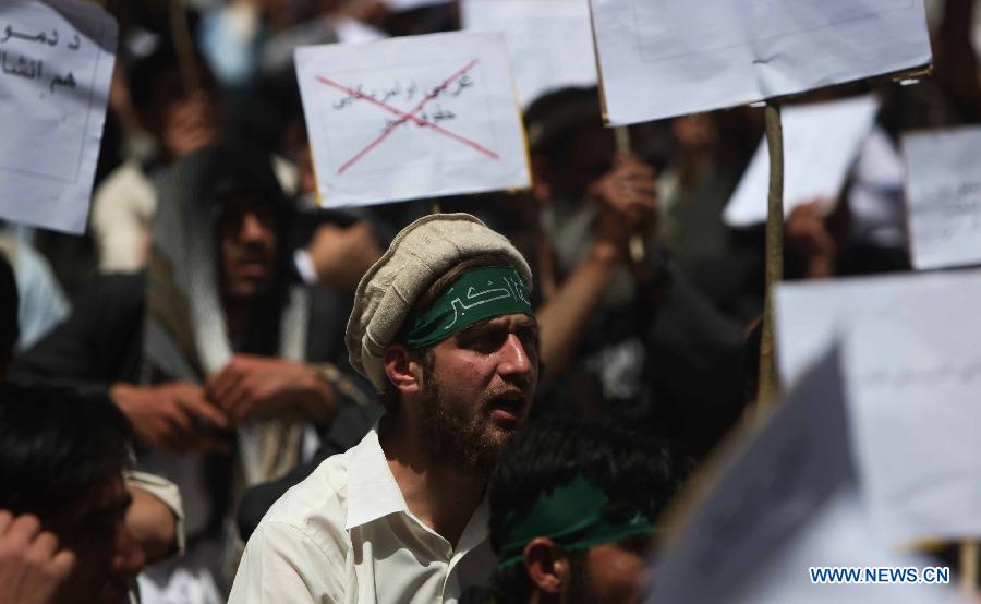 Afghan university students chant slogans during a protest against the Elimination of Violence against Women (EVAW) law, in Kabul Afghanistan on May 22, 2013. The protesters said parts of the EVAW law, endorsed by Afghan President Hamid Karzai in 2009, are against Islamic teaching. The law has yet to be ratified by the parliament. (Xinhua/Ahmad Massoud) 