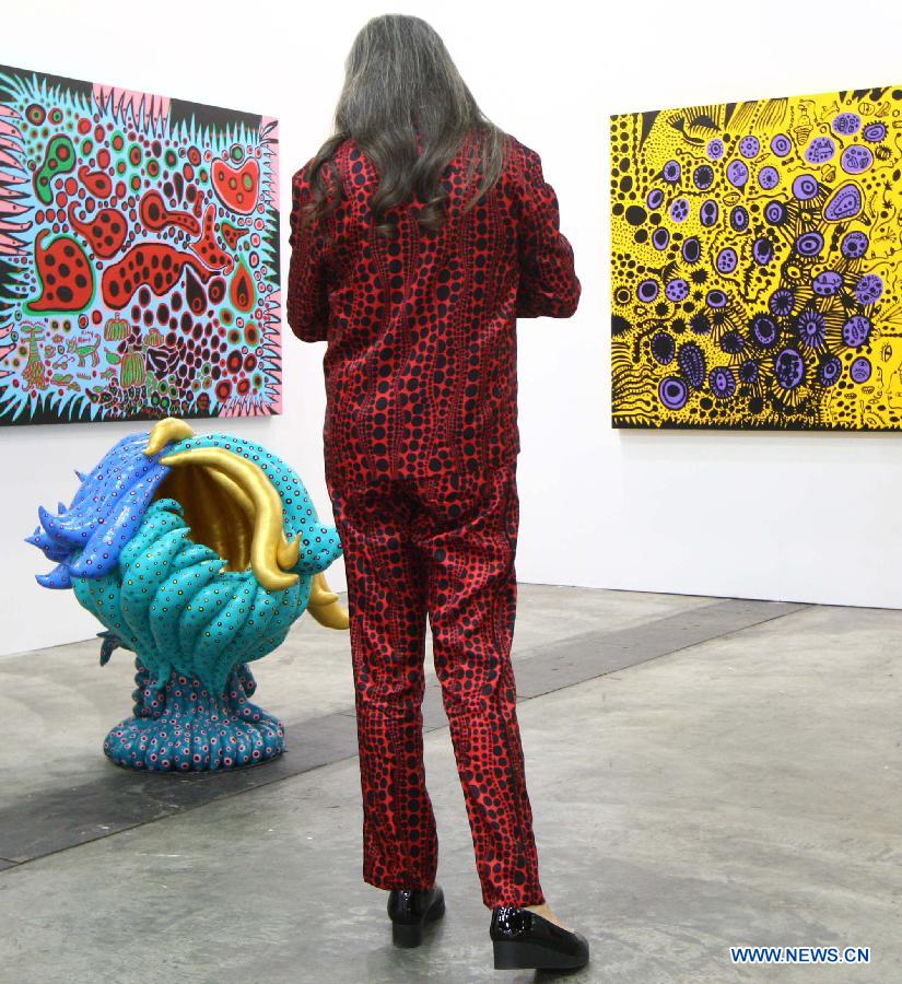 A woman stops in front of an exhibit during the exhibition Art Basel in Hong Kong, in south China's Hong Kong, May 22, 2013. Art Basel in Hong Kong, the latest leg of the international circuit, will kick off here on Thursday. (Xinhua/Lui Siu Wai) 