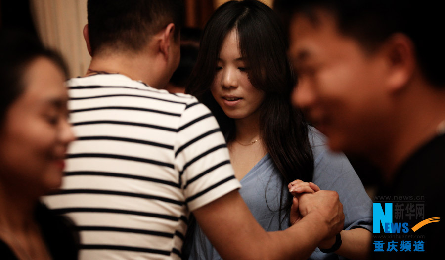 People dance Salsa in a dancing party in Chongqing.