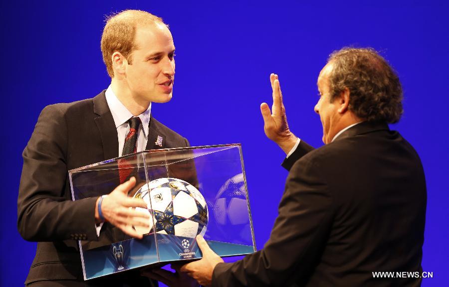 UEFA president Michel Platini (R) presents gifts to Prince William (L), the Duke of Cambridge, during the XXXVII Ordinary UEFA Congress 2013 at Grovesnor House Hotel in London, Britain, on May 24, 2013. (Xinhua/Wang Lili) 