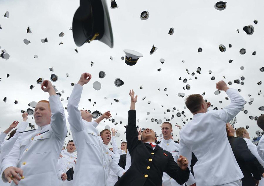 Members of the 2013 graduating class of the United States Naval Academy throw their caps into the air marking the end of their commencement ceremony in Annapolis, Maryland, May 24, 2013. (Xinhua/AFP Photo)