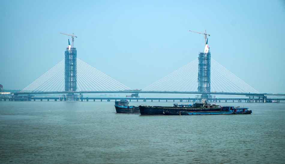 The grand-block joining of Rugao Bridge is done on the Yangze River on May 20, 2013. Rugao Bridge was designed as a cable-stayed bridge with twin towers and the construction began on August, 2010. The project which cost 560 million yuan ($91.3 million) is expected to complete and open to traffic by the end of 2013. (Xinhua Photo/ Huanzhe)