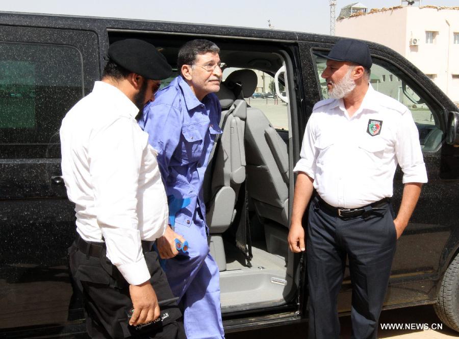 Former Libyan foreign intelligence chief Bouzid Dorda (C) arrives at a hearing in his trial in Tripoli on May 28, 2013. The former foreign intelligence chief, the first of Moamer Kadhafi's top officials to face justice, is accused of ordering security forces to use live ammunition against demonstrators last year.(Xinhua/Hamza Turkia)