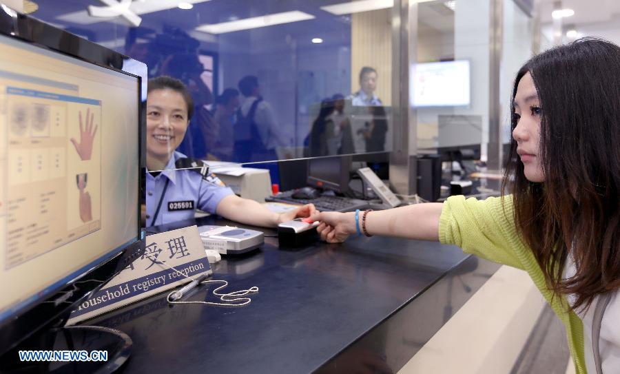 A citizen registers her fingerprint information at a police station in Shanghai, east China, May 30, 2013. The Shanghai police announced on Thursday that the city will start collecting fingerprint information of its citizens for ID card recognition across the region as of July 1, which can help better protect the legal rights of the citizens and also safeguard state safety and social stability. The city has by far started the program in 233 police stations and has registered the fingerprint information of 10,756 citizens. (Xinhua/Fan Jun) 