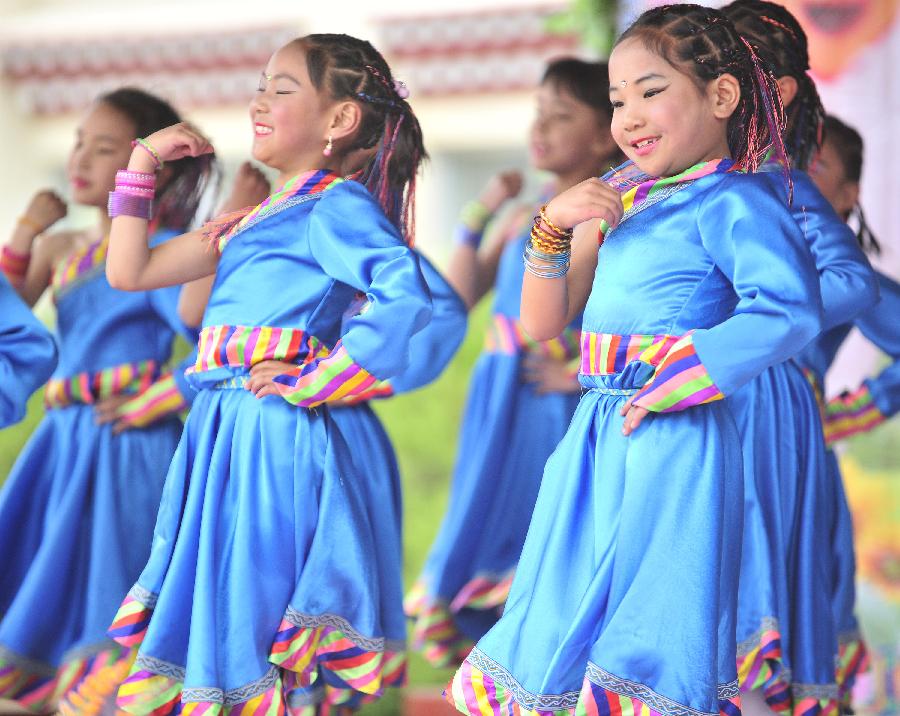 Students perform dance to celebrate the coming International Children's Day in Lhasa, capital of southwest China's Tibet Autonomous Region, May 30, 2013. Various activities are held to celebrate the coming International Children's Day. [Photo/Xinhua]