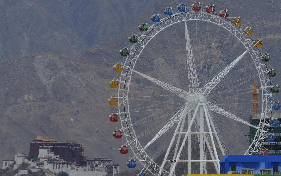A Ferris wheel is seen at the first modern amusement park in Lhasa, capital of southwest China's Tibet Autonomous Region, May 31, 2013. Designed for children and appropriately named "Happy Baby" in the Tibetan language, the park started business Friday to mark the International Children's Day. (Xinhua/Purbu Zhaxi)