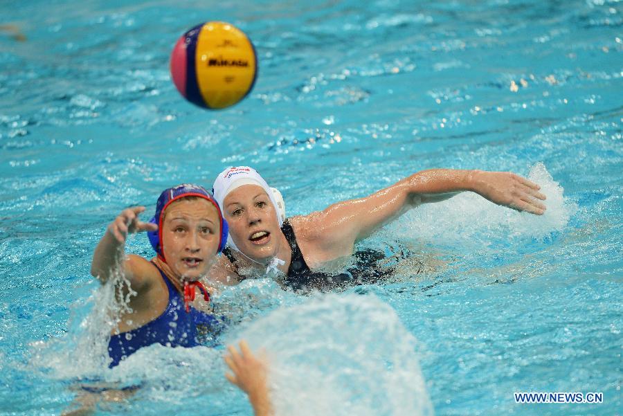 Orsolya Takacs (R) of Hungary vies for the ball during their match against Russia at the 2013 FINA Women's Water Polo World League Super Final in Beijing, capital of China, June 1, 2013. Hungary won 11-10. (Xinhua/Tao Xiyi) 