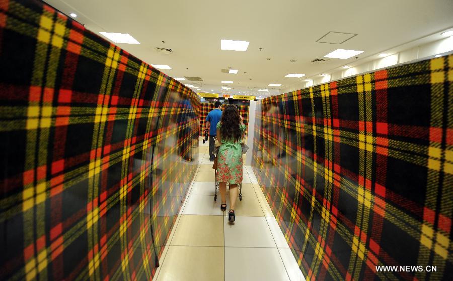 Customers walk between the covered shelves at the Japan-based Isetan Supermarket in Shenyang, capital of northeast China's Liaoning Province, May 31, 2013. Isetan Mitsukoshi Holdings Ltd. closed its department store in Shenyang on June 1, 2013 amid poor business conditions. Earlier, Isetan Mitsukoshi closed other two stores respectively in east China's Shanghai and Jinan. (Xinhua/Yao Jianfeng)  