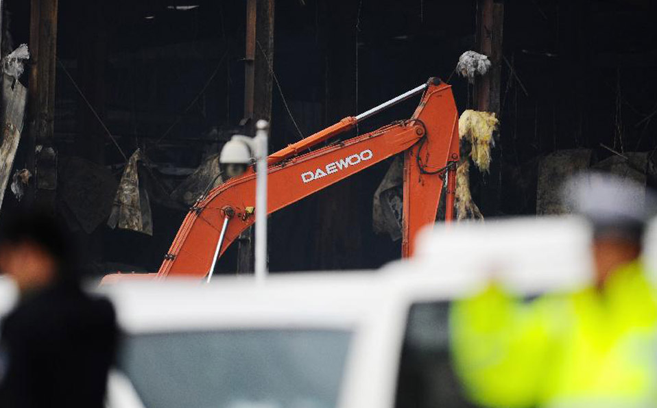 Rescuers work at the accident site after a fire occurred in a slaughterhouse 