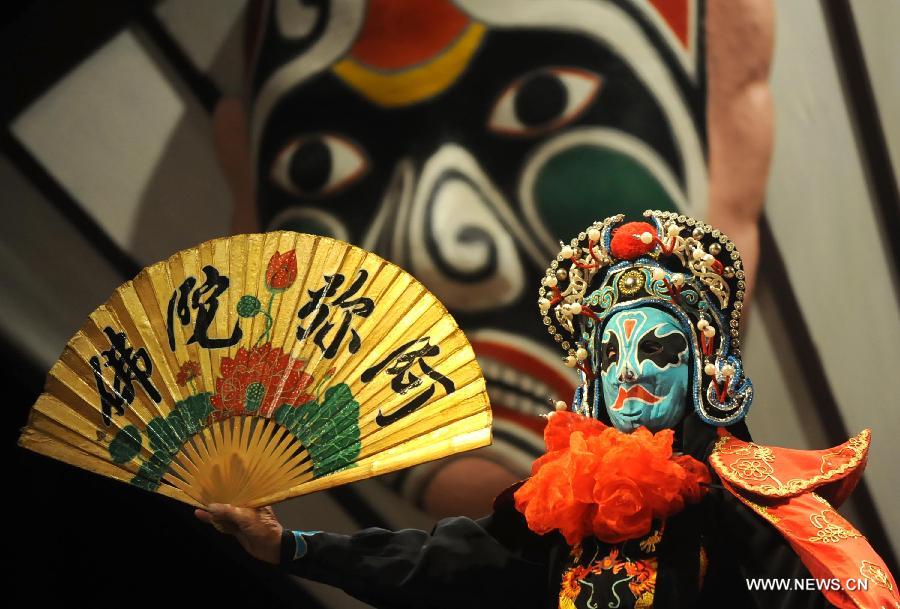 File photo taken on Aug. 19, 2012 shows an actor performs face-changing, a stunt technique in Sichuan opera, at the Wuhou Shrine Museum in Chengdu, capital of southwest China's Sichuan Province. Sichuan opera is one of the oldest forms of Chinese opera, distinguished by face-changing, fire-spitting and other stunts. Regionally Chengdu remains to be the main home of Sichuan opera, while other influential locales include Yunnan, Guizhou and other provinces in southwest China. (Xinhua/Xue Yubin)  