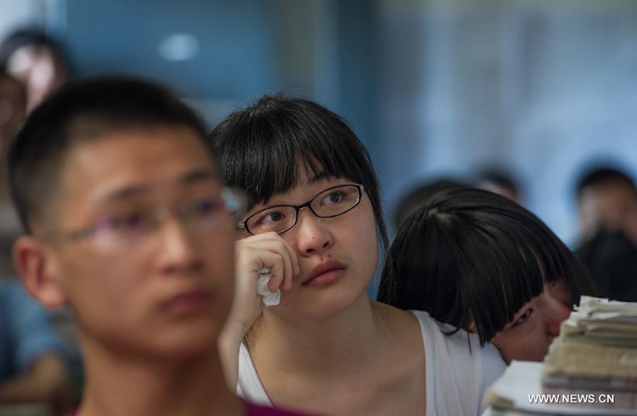 A student cries on the occasion of her graduation at the Yucai Middle School in Chongqing, southwest China, June 4, 2013. Three days later, the high school graduates will take part in the national college entrance exam, which is set for June 7 and 8. (Xinhua/Chen Cheng) 