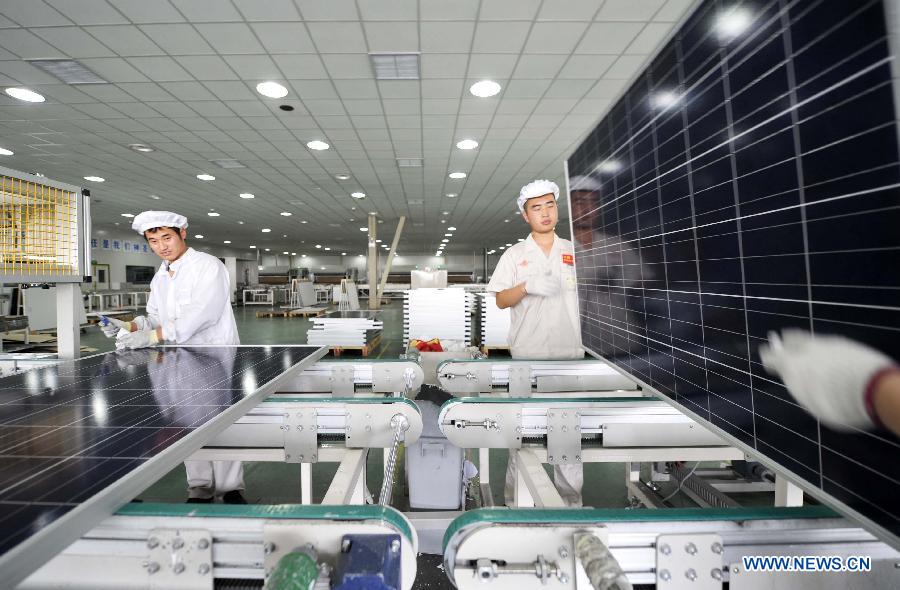 Employees assemble solar panels in a factory owned by photovoltaic products maker Yingli Solar in Tianjin, north China, June 5, 2013. Spokesman of China's Ministry of Commerce Shen Danyang said on June 5 China firmly opposes the European Commission's decision to slap provisional antidumping duties on Chinese solar panels. Shen added that it came despite herculean efforts and utmost sincerity from the Chinese side. On June 4, the European Commission announced its decision to introduce antidumping duties on solar panels imported from China. An interim punitive duty of 11.8 percent will apply to all Chinese solar panel imports starting from Thursday, and the duty will be raised to an average of 47.6 percent in two months if the two sides fail to find a solution. (Xinhua/Yue Yuewei)