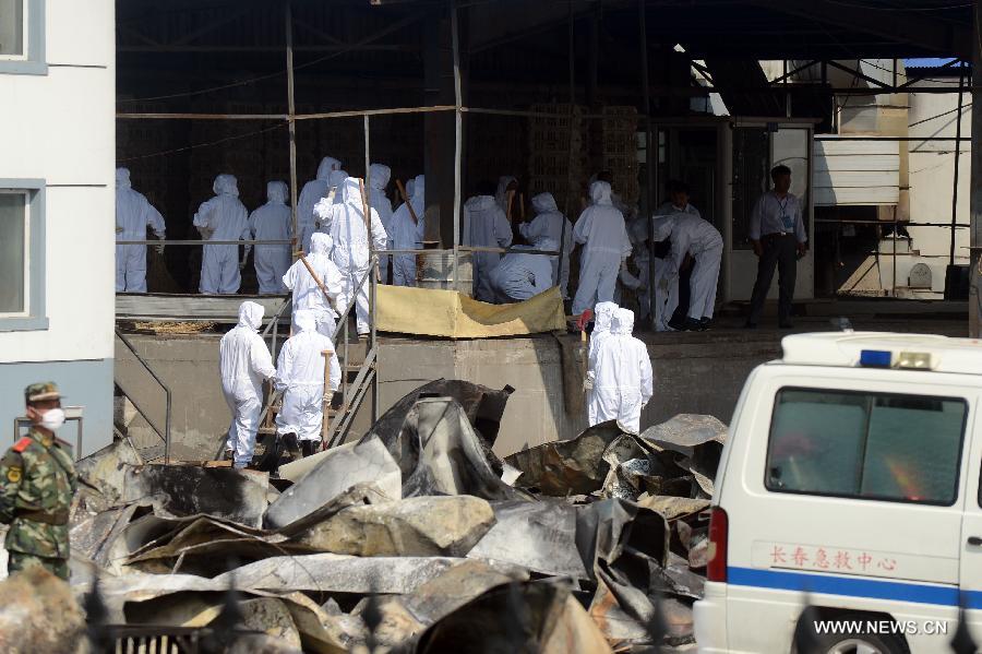 Health workers carry out disinfection work at the accident site after a fire broke out at a poultry processing workshop owned by the Jilin Baoyuanfeng Poultry Company in Mishazi Township in the city of Dehui, northeast China's Jilin Province, June 6, 2013. The fire, which occurred early Monday morning, killed 120 people and injured 77 others. (Xinhua/Lin Hong)