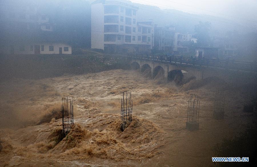 A building site is flooded in Gaoluo Township, Xuan'en County, Enshi Tujia and Miao Autonomous Prefecture of central China's Hubei Province, June 6, 2013. Torrential rainfall made parts of Enshi flooded on Thursday morning, and a total of 513 residents have been evacuated. (Xinhua)