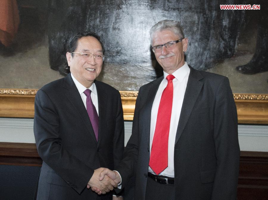 Yu Zhengsheng (L), chairman of the National Committee of the Chinese People's Political Consultative Conference, shakes hands with Danish Parliament Speaker Mogens Lykketoft in Copenhagen, Denmark, June 6, 2013. (Xinhua/Li Xueren)