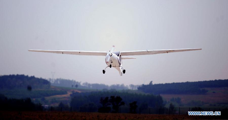 An electric two-seater light sport airplane flies over the Caihu Airport in Shenyang, capital of northeast China's Liaoning Province, June 7, 2013. The lithium-battery-powered aircraft, independently-developed by Shenyang Aerospace University, had a successful test flight Friday. (Xinhua/Yang Qing)