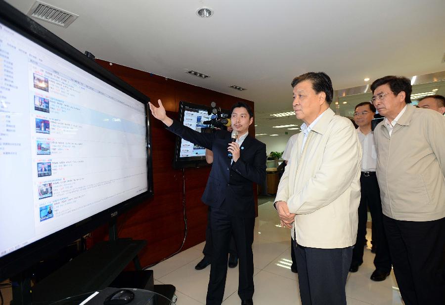 Liu Yunshan (2nd L), a member of the Standing Committee of the Political Bureau of the Communist Party of China (CPC) Central Committee and member of the Secretariat of the CPC Central Committee, visits the TVMining Media Technology Co., Ltd. in Beijing, capital of China, June 8, 2013. Liu visited several enterprises in Beijing Saturday to conduct a survey.(Xinhua/Li Tao) 