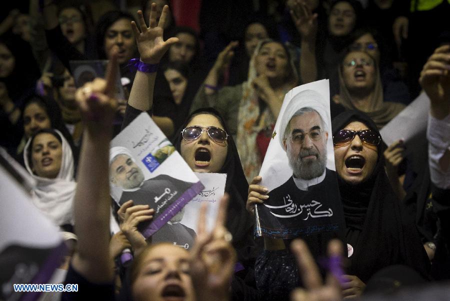 Supporters shout slogans during a campaign rally of Iran's moderate presidential candidate Hassan Rouhani, in downtown Tehran, capital of Iran, on June 8, 2013. (Xinhua/Ahmad Halabisaz) 