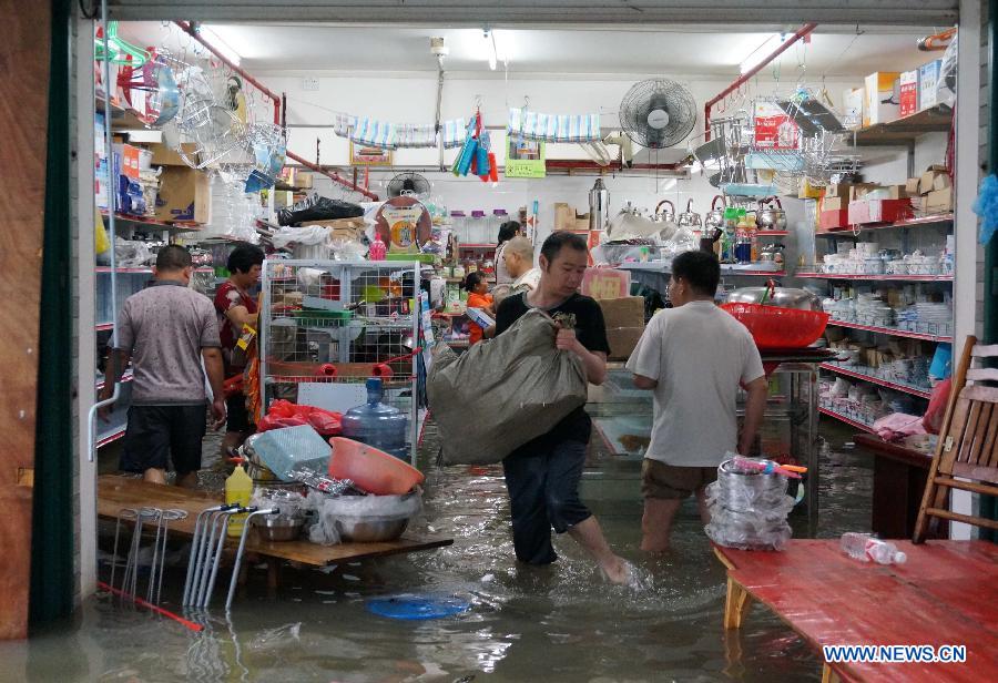 People try to salvage goods in a flooded shop in Rongshui Miao Autonomous County, south China's Guangxi Zhuang Autonomous Region, June 9, 2013. Heavy rains have hit the county since June 8, triggering floods and disrupting traffic and telecommunications in some areas. (Xinhua/Long Tao) 