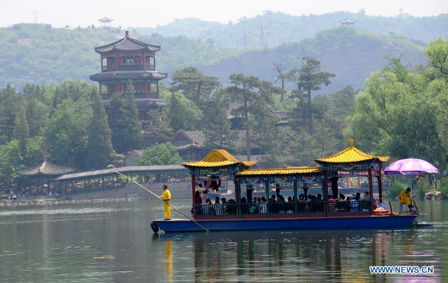 Tourists enjoy themselves on a pleasure-boat in the Summer Resort in Chengde, north China's Hebei Province, June 12, 2013. As summer comes, tourist destinations in Chengde attracted many visitors during the three-day Dragon Boat Festival vacation from June 10 to June 12. Chengde is a city well known for its imperial summer resort of the Qing Dynasty (1644-1911). (Xinhua/Wang Xiao) 