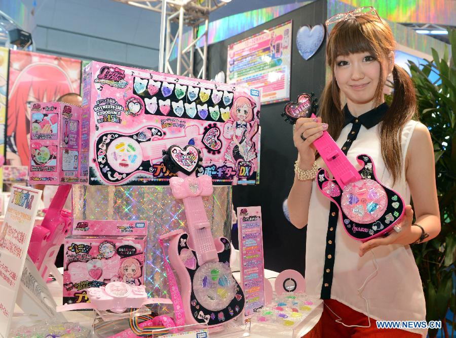 An exhibitor displays a toy guitar at the annual International Tokyo Toy Show on June 13, 2013. The International Toy Show kicked off here on Thursday. (Xinhua/Ma Ping) 