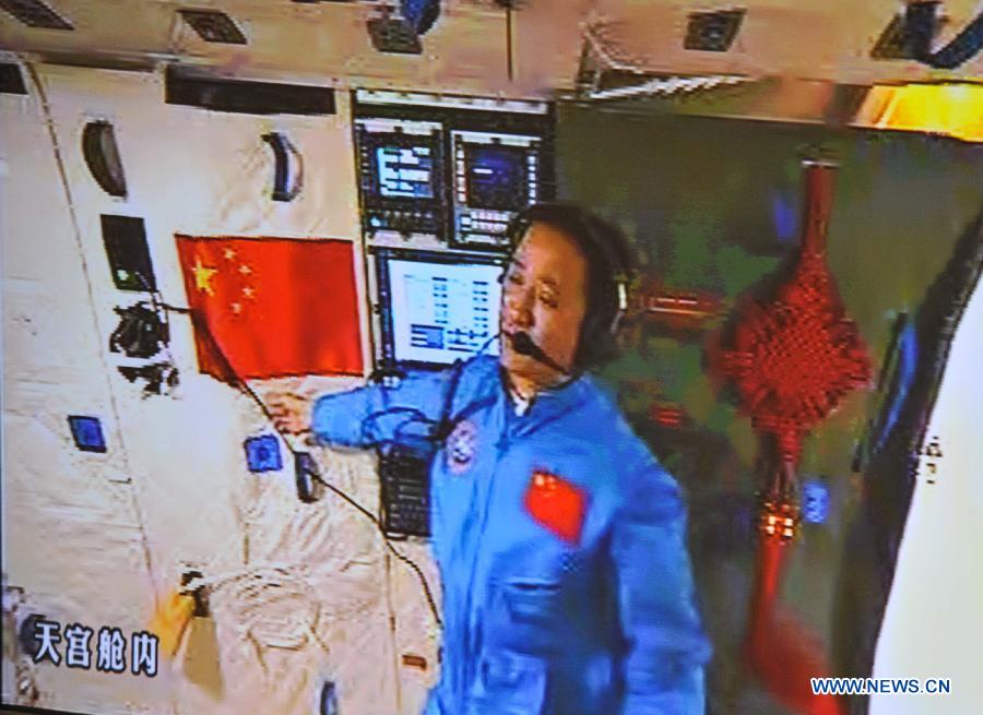 Photo taken on June 13, 2013 shows the screen at the Beijing Aerospace Control Center showing Nie Haisheng contacting with the ground base after entering the Tiangong-1 space module. China's Shenzhou-10 manned spacecraft successfully completed an automated docking with the orbiting Tiangong-1 space module at 1:18 p.m. Thursday and the astronauts Nie Haisheng, Zhang Xiaoguang and Wang Yaping opened the hatch of Tiangong-1 at 4:17 p.m. (Xinhua/Liu Chan)