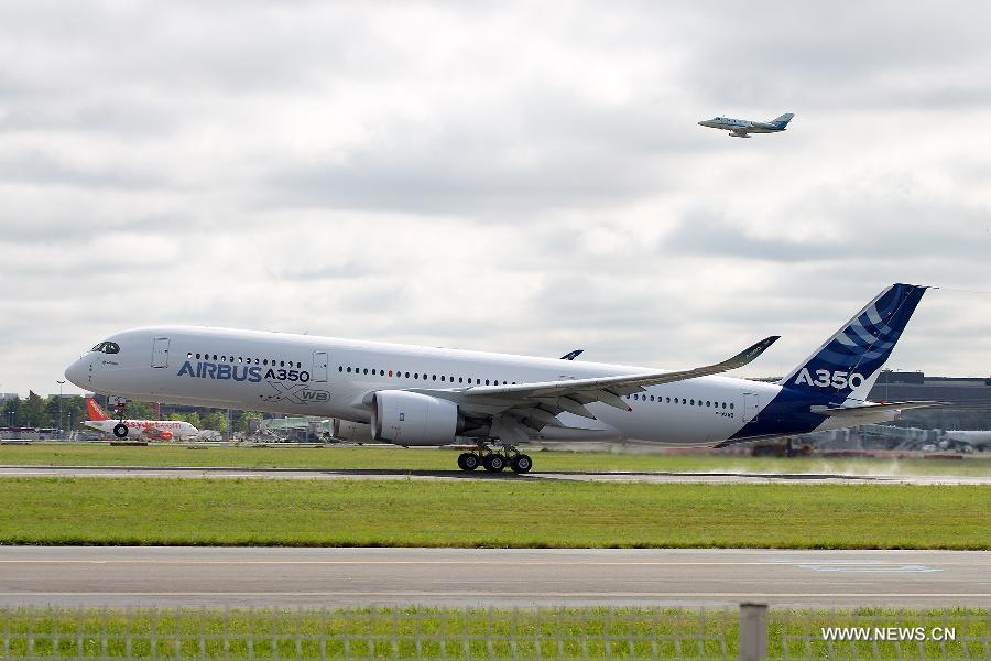 Airbus's A350 XWB (eXtra Wide Body) plane is about to take off from Toulouse-Blagnac airport, southwestern France, on its first test flight on June 14, 2013. The A350 XWB is Airbus' all-new mid-size long range product line. To date it has already won 613 firm orders from 33 customers worldwide. (Xinhua/Chen Cheng)