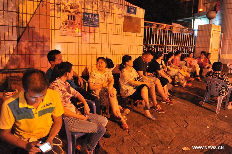 Parents queue at the gate of the Kindergarten of the Gubu Road of Liuzhou City, south China's Guangxi Zhuang Autonomous Region, June 14, 2013. Most kindergartens in Liuzhou started the registration for new students on June 15 and 16, when some parents who wanted to send their children into public kindergartens queued for the whole night for the registration. There are more than 200 kindergartens in Liuzhou City, in which only 14 are public ones. Attracted by the low costs and good reputation of the public kindergartens which often enroll limited number of students every year, some parents spare no effort in striving for the registration. Many parents even queue for the whole night for the registration, which has become a common phenomenon in many places of the country. (Xinhua/Li Bin)