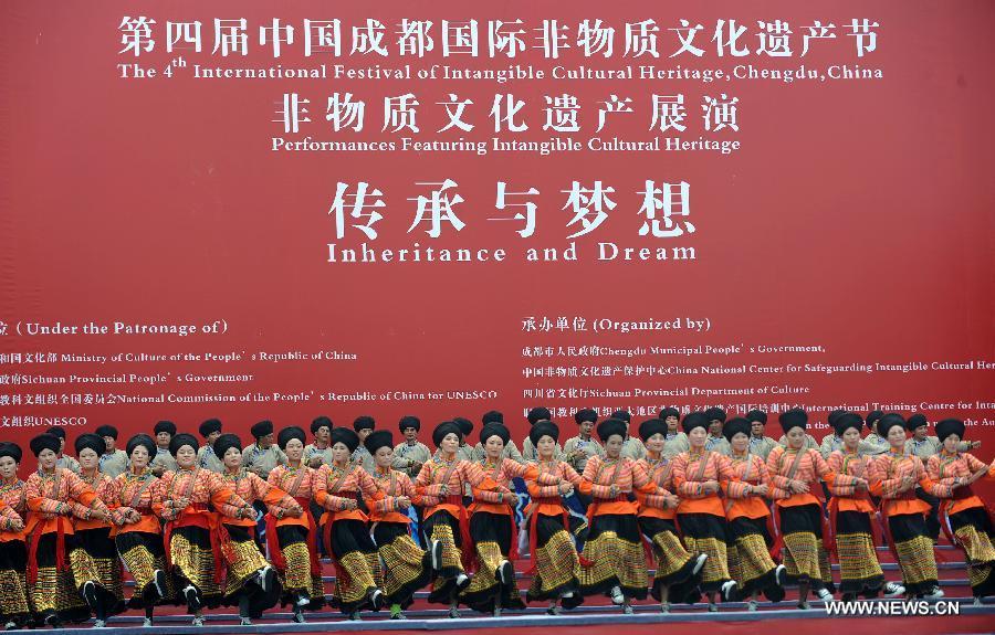 Actors give dance performances in style of the Lisu ethnic group at the opening ceremony of the 4th International Festival of Intangible Cultural Heritage in Chengdu, capital of southwest China's Sichuan Province, June 15, 2013. The nine-day festival kicked off here on Saturday. (Xinhua/Xue Yubin)  