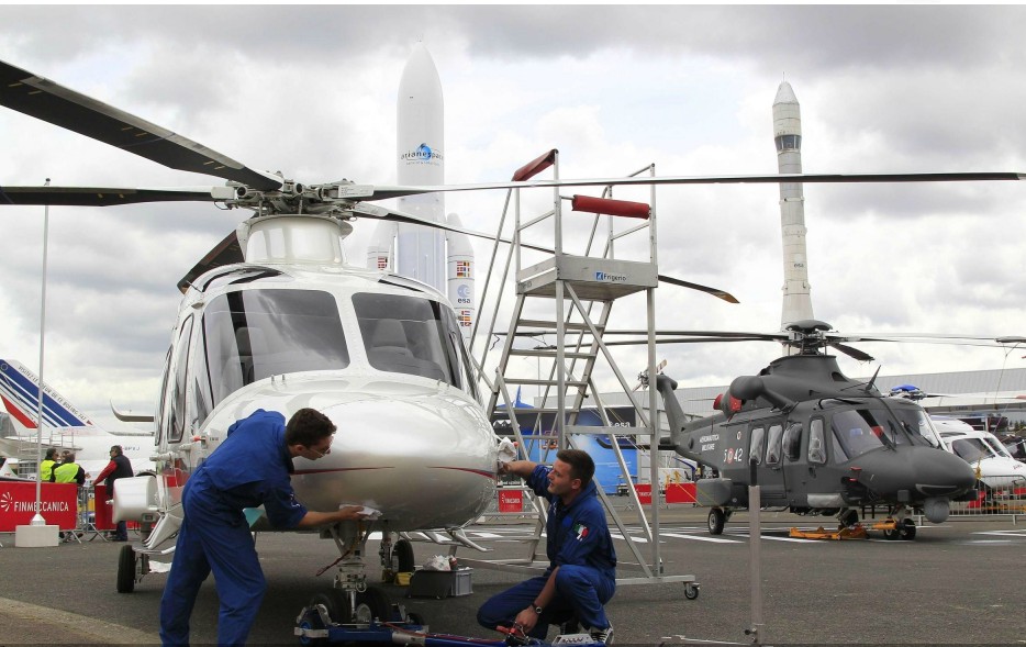 Workers clean an AgustaWestland helicopter AW169 in static display, two days before the opening of the 50th Paris Air Show, at the Le Bourget airport near Paris, June 15, 2013. (Photo Source: chinadaily.com.cn) 