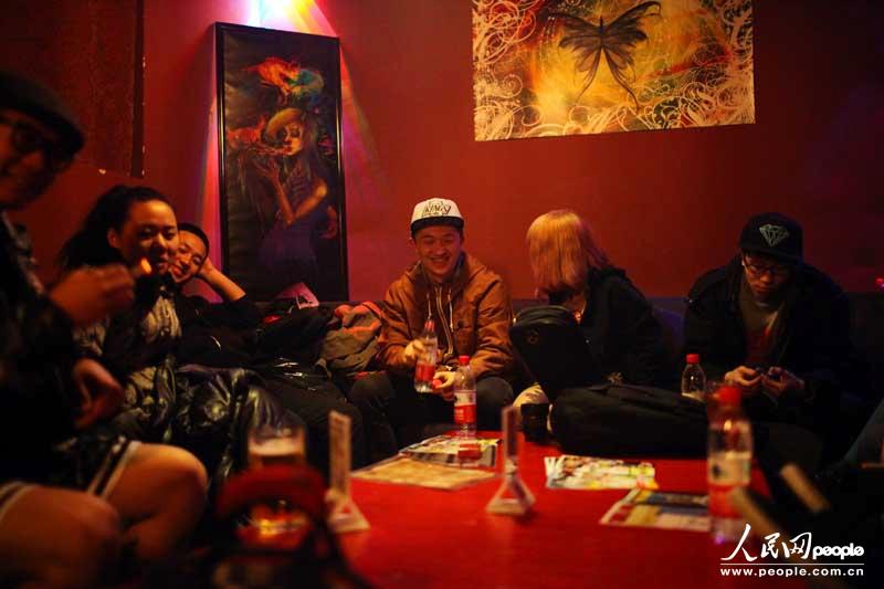 Ren Yingjing and his band member take rest in the private room of a bar before the show. (People's Daily Online/ Sun Bowen)