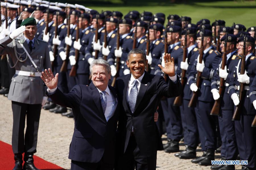 U.S. President Barack Obama (R) and German President Joachim Gauck (L) greet people during a welcoming ceremony at the Presidential Palace in Berlin, Germany, June 19, 2013. Obama arrived in Berlin on June 18 for an official visit. (Xinhua/Pan Xu)