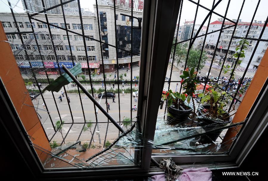 The window glass of a nearby apartment is shattered by the shockwave of a restaurant blast in Shuozhou City of north China's Shanxi Province, in the early morning of June 20, 2013. Blasts ripped through a restaurant in Shuozhou Wednesday night, killing three people and injuring 149 others. (Xinhua/Yan Yan)