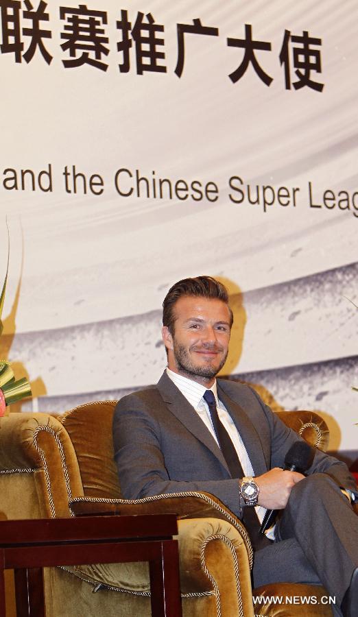 Former England soccer captain David Beckham smiles during a news conference in Shanghai, east China, June 20, 2013. Beckham arrived in China on Monday for a seven-day visit as the ambassador for the Youth Football Programme in China and China's Super League. (Xinhua/Fan Jun)