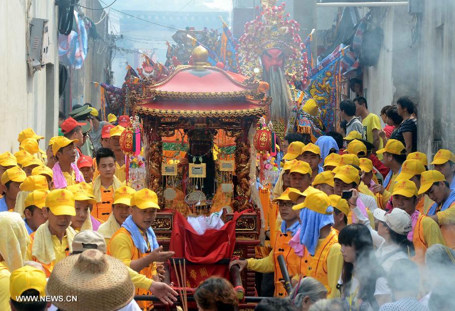 Locals participate in an annual parade honoring Guandi at Tongling Town in Dongshan County, southeast China's Fujian Province, June 20, 2013. Guandi, namely Guan Yu, was a senior general of shu han (221-263) during the three kingdoms period. Guan had been deified by feudal rulers of past ages because of his loyalty to his kingdom and was dubbed "guandi (emperor guan of military strategies)". Guan and confucius, known as the "emperor of education", were usually considered equal in status. (Xinhua/Wang Song)