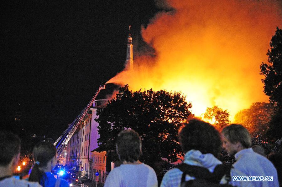 A firefighter tries to extinguish blaze on the roof of Riga Castle, Latvia, June 20, 2013. A massive roof fire was reported at the Riga Castle, office of the Latvian President. No casualty was reported. Due to ongoing renovation, the presidential office was temporarily moved to the Blackheads House, another historic landmark in the Latvian capital. (Xinhua/Guo Qun) 