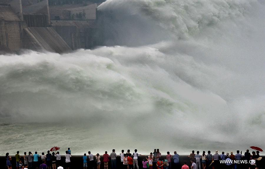Tourists watch as water gushing out of the Xiaolangdi Reservoir on the Yellow River during a water and sediment regulating operation in Sanmenxia City of central China's Henan Province, June 22, 2013. The water and sediment regulating operation of Xiaolangdi Reservoir is conducted every year to clear out the mud and sand accumulated at the dam. (Xinhua/Wang Song) 