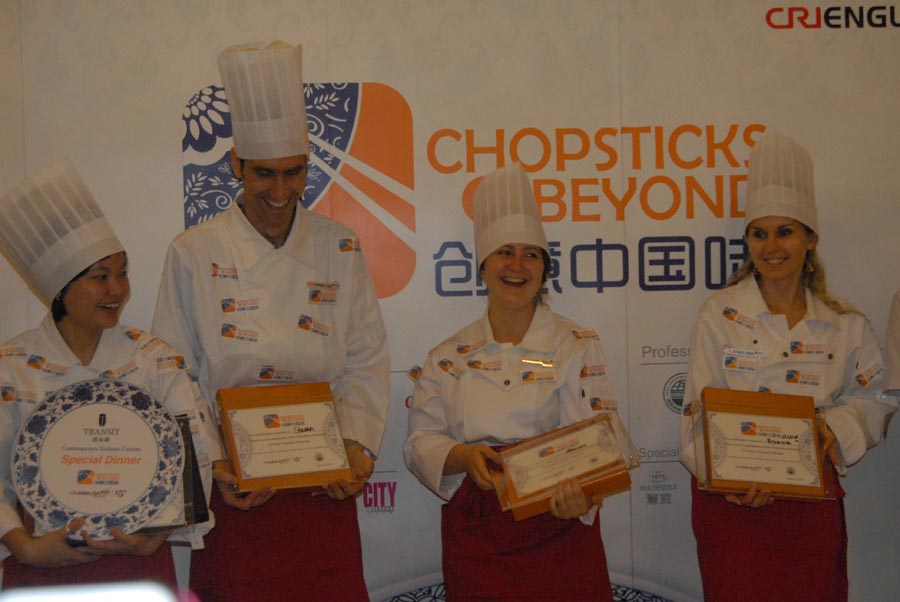 Contestants pose for group photo at the prize award ceremony of "Chopsticks and Beyond" in Beijing, June 22, 2013. "Chopsticks and Beyond" is a Chinese cuisine challenge launched by CRIENGLISH.com to provide a platform for foreign food enthusiasts to show off their Chinese cooking skills and explore creative dishes with exotic flavor. It features China's four great traditions: Sichuan Cuisine, Cantonese Cuisine, Shandong Cuisine and Huaiyang Cuisine.(Xinhuanet/Yang Yi)