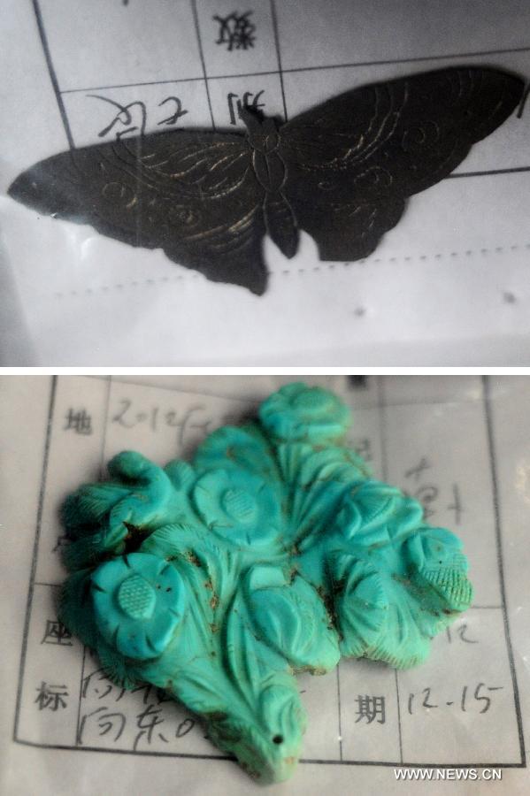 Combination photo taken on June 22, 2013 shows a silver butterfly (upper) and a calaite ornament found at the archeological site of an ancient tomb in Fangshan District of Beijing, capital of China. A gravestone excavated from the tomb confirmed that the tomb was the final resting place of Liu Ji, a regional military governor of the Tang Dynasty (618-907), and his wife. Archaeologists have started a salvage excavation of the tumulus since August 2012, after it was accidentally discovered at a local construction site. Valuable cultural relics, including an exquisite stone coffin bed, were discovered. (Xinhua/Luo Xiaoguang)  