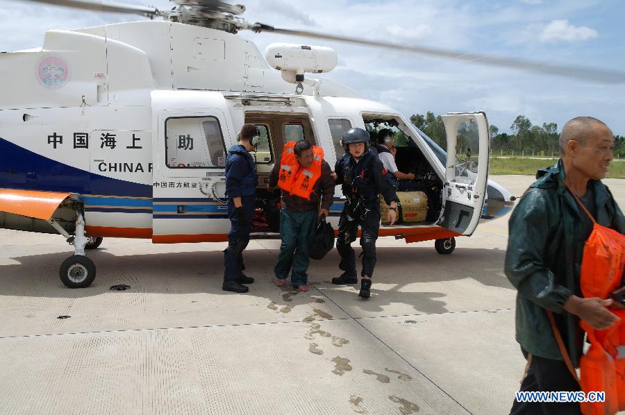 Seamen on a wrecked freighter are transported by a helicopter after being rescued to Sanya, southernmost China's Hainan Province, June 23, 2013. Feignters "Changxinshun 888" and "Jinma 788" capsized due to the arrival of tropical storm Bebinca near Basuo Port in Dongfang City of Hainan Sunday. All the 12 crew members were saved by local maritime safety administration and the First Rescue Squadron of the South China Sea. (Xinhua) 