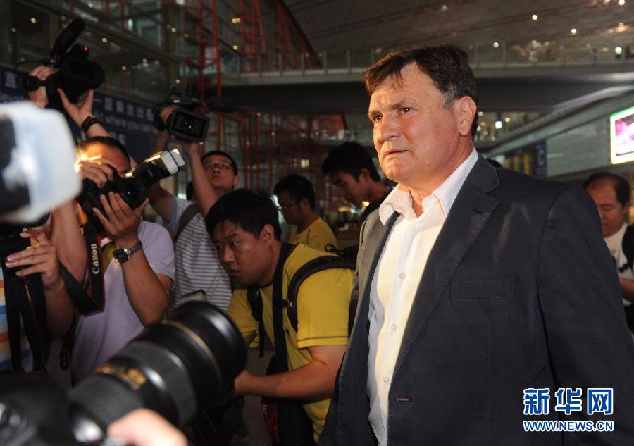 China's head coach Jose Antonio Camacho receives an interview after arriving at Beijing Capital International Airport, Aug. 13, 2011. (Photo/Xinhua)